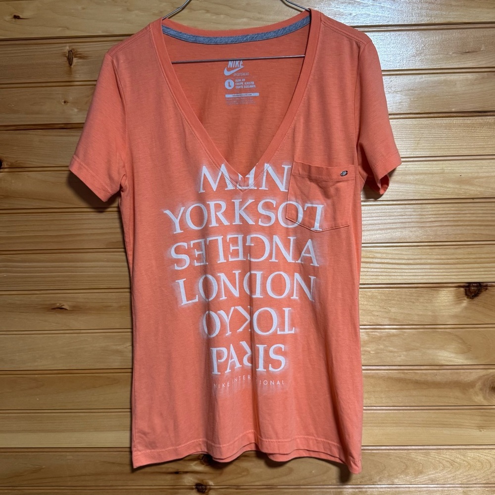 Nike International Women’s V-Neck Soft Orange Tee List of International Cities L